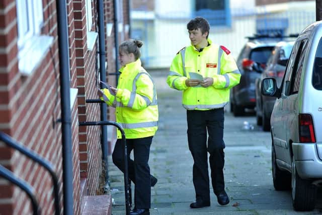 Police volunteer cadets Katie Blyth and Joshua Nesbitt put copies of the leaflet through letter boxes in the East End.