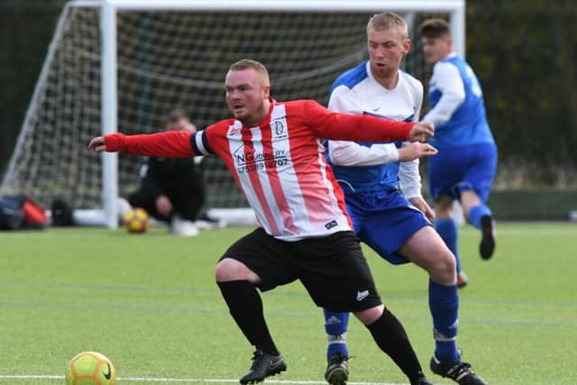 AFC Donkins (red and white) take on Willow Pond last week. Picture by Kevin Brady