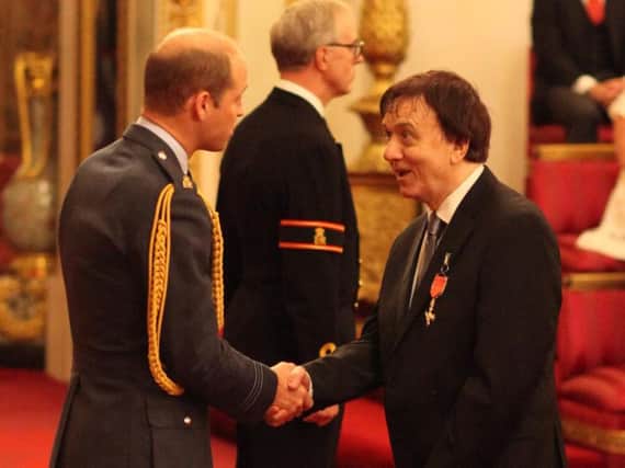 Tom Hurst receiving his OBE.