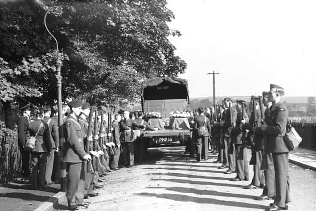 RAF personnel form a guard of honour at the funeral of the German aircrew