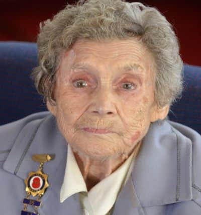 Mrs Mary Reid with her medal, the Gold Cross of Honour of the German War Graves Commission