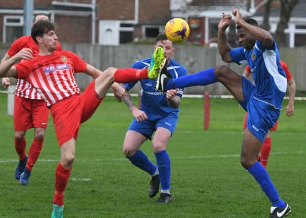 High feet as Ryhope CW (red/white) take on Harrogate RA in the FA Vase on Saturday. Picture by Kevin Brady