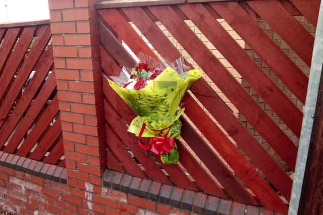 Flowers left outside a house in Kemble Square, Downhill, where Barry Solomon was pronounced dead.