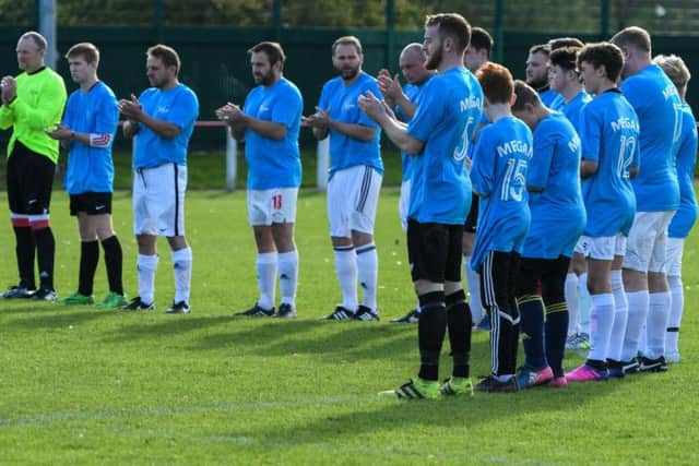 A minute's applause was held before the game.