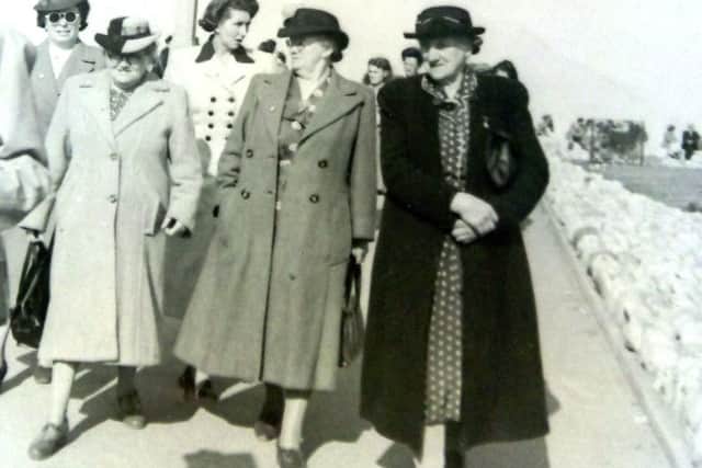 Grace, far right, walks with friends along the promenade.