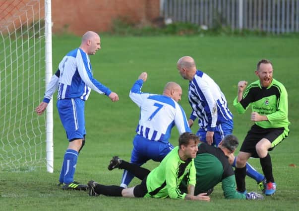 Roseberry Grange (green) celebrate scoring against Willow Pond last weekend. Picture by Tim Richardson