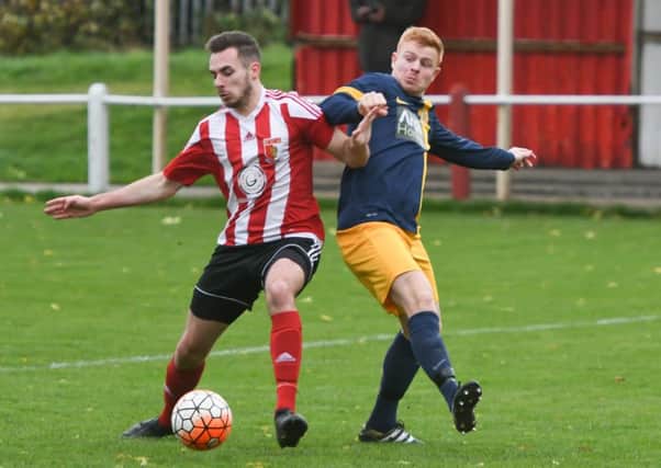 Sunderland RCA's Stephen Callen (red/white) battles against Ashington's Ben Christiansen at  Meadow Park on Saturday.  Picture by Kevin Brady.