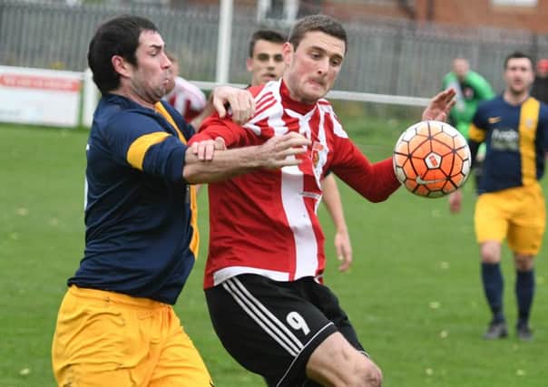 Sunderland RCA's Nathan O'Neill (red/white) comes under pressure from an Ashington defender. Picture by Kevin Brady.
