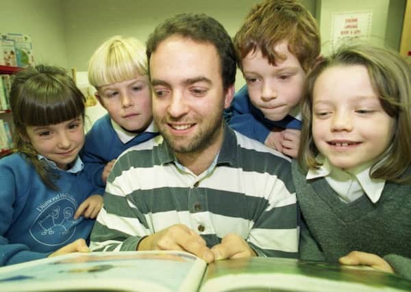 The opening of the new school library with children's author Rob Lewis in 1993 - but who are the children with him?