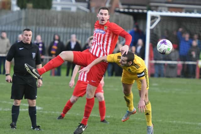Ryhope CW's Chris Trewick (red/white) scraps for the ball against Vase visitors City of Liverpoool. Picture by Kevin Brady
