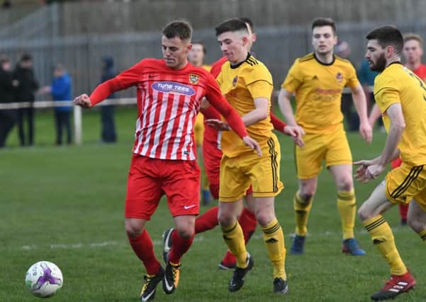 Ryhope CW's Matty Weirs (red/white) comes under pressure against City of Liverpoool in Saturday's FA Vase tie. Picture by Kevin Brady