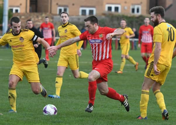 Ryhope CW's James Ellis (red/white) takes on the City of Liverpoool defence in last week's FA Vase tie. Picture by Kevin Brady