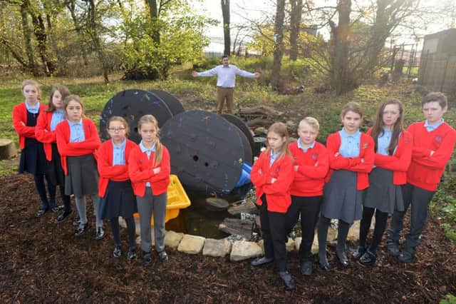 Vandals have destroyed New Seaham Primary School's new wildlife pond. Pupils pictured with assistant headteacher Steve Bilton.