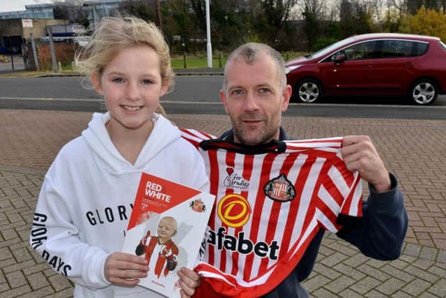 Grace Phillips with her dad Chris with the Bradley Lowery shirt. Picture by Frank Reid