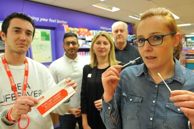 Pallion Trader Zoe Jameson takes a swab test, watched by traders, Atif Bilal, Paula Brown, and Richard Downey, with Jason Gray, left.