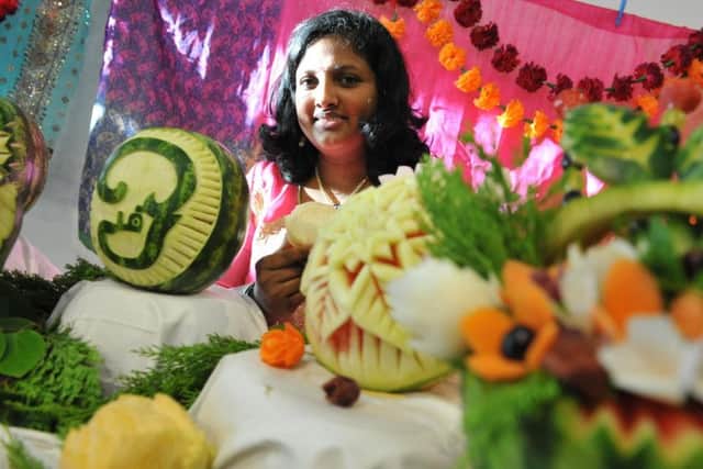 Vijayalakshmi Subramani with her fruit carvings at Sunderland's Diwali Festival.