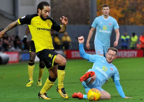 Grounded Aiden McGeady keeps the ball under pressure from Sean Scannell at Burton.