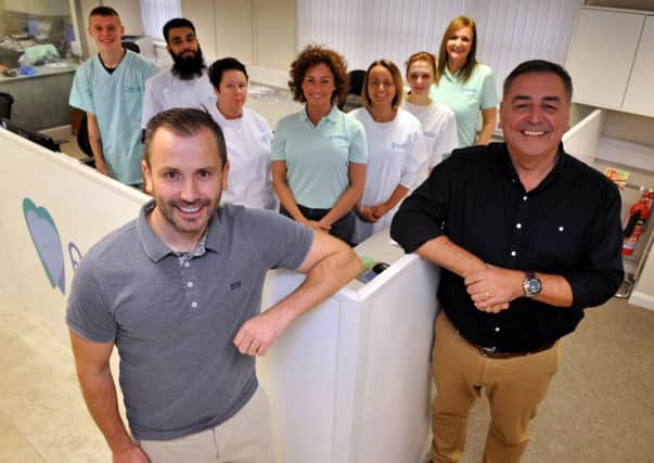 Ashford Orthodontics directors Craig Stevens (left) and Sean Thompson (right) with seven of their nine new employees.
