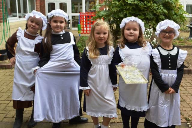 Youngsters ready to serve in a Victorian household.