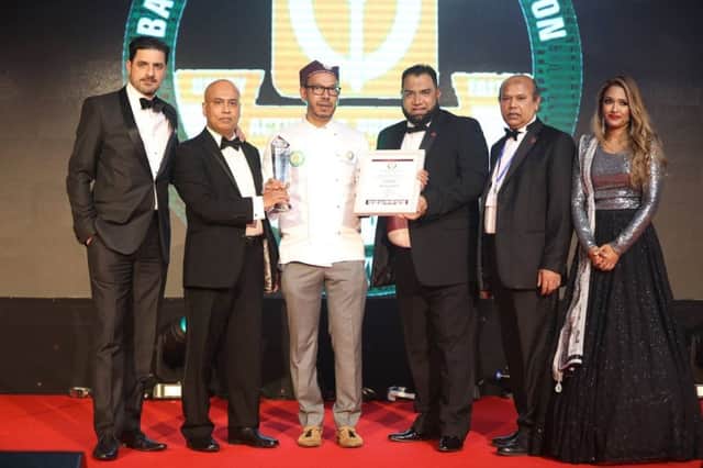 Ali Hussain, centre, collecting his award in London
