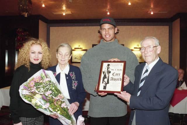 Retro 1995   Mr Courage  December 23 1995  old ref number 1995   
Proud pensioner Tommy Reilly of Hylton Castle won the hearts of Sunderland people by tackling two teenage thugs was publicly acclaimed.  TV Gladiator Hunter presented Tommy and his wife, Florence with a certificate and flowers at a special Christmas dinner organised by the city's Lazarus Foundation. Pictured: Tommy receiving his award from Hunter. Donna Craig, trustee of the Foundation, presents the bouquet to his wife, Florence.