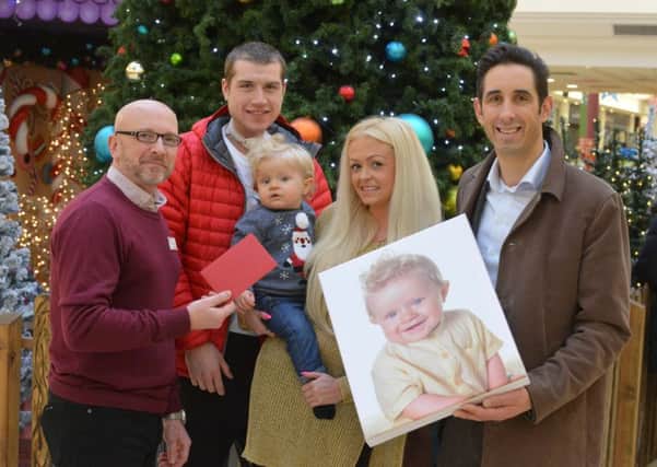 Bonnie Babies prize handover to mother Melissa Wailes, father Jonathan Thornton and baby Lyle Rocco Thornton. Bridges centre manager John Green (L) and Focal Point's David Shilling (R)