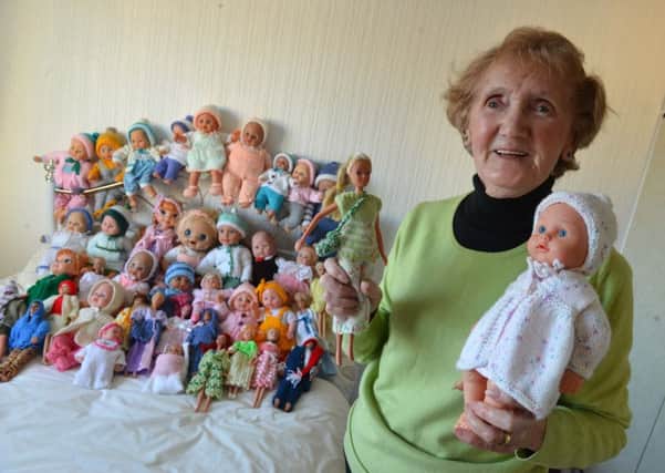 Keen knitter Rose Blake with some of the dolls she is donating to the Echo Toy Appeal.