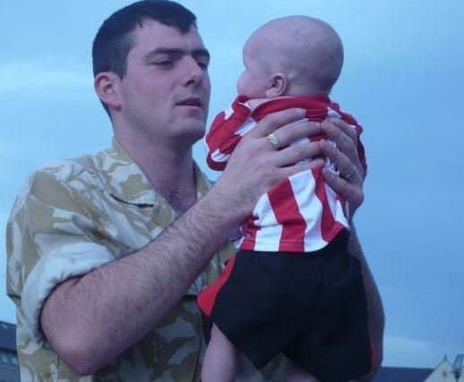 Lance Corporal Christopher Roney, of 3rd Battalion the Rifles, with his baby boy William.