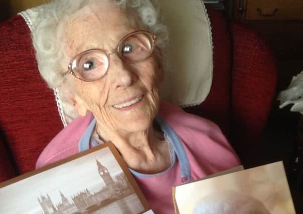 Edith May Curtis with her card from the Queen to mark her 100th birthday.