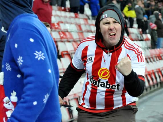 A Sunderland fan celebrates.