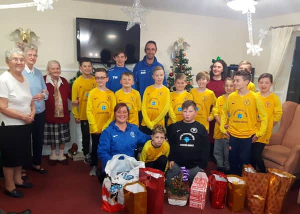 Velocity Phoenix under-11s team with residents at Hylton View Care Home.
