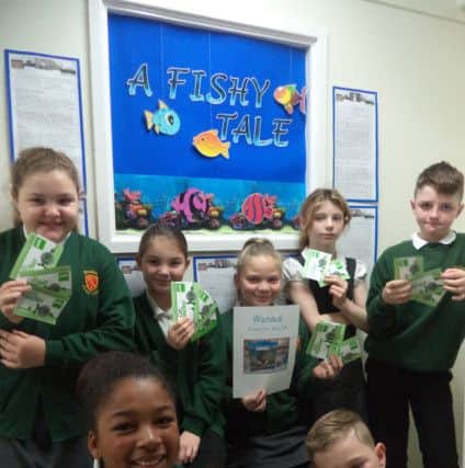 Youngsters with their vouchers to spend at Pets at Home.