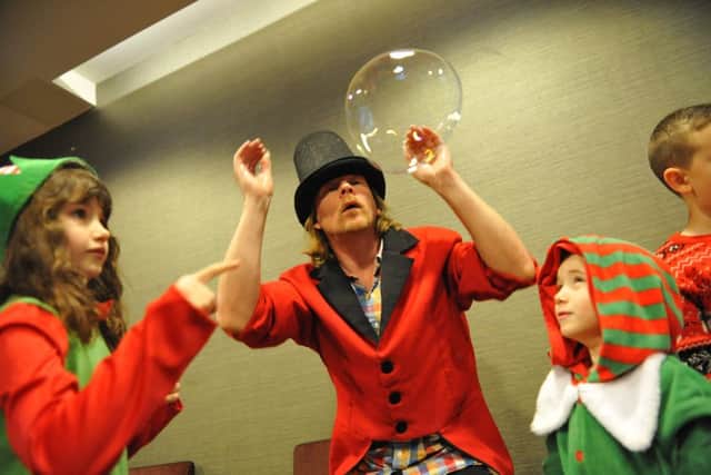 Youngsters are entertained at the Rainbow Trust's Christmas Party by bubble man Richard Shaw.
