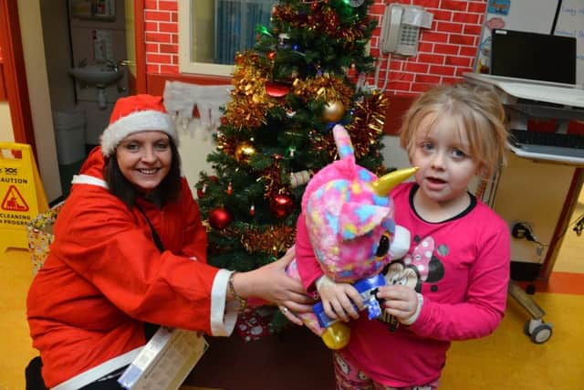 Fundraiser Emma Olsen donates Christmas presents to Sunderland Royal Hospital. Patient Lacey Mae Hobson, 5