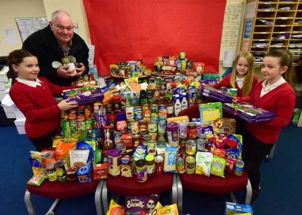 Brian Wilson of the East Durham Trust collecting food for their food bank that has been donated by pupils at South Hetton Primary School. Pictured with Brian are organisers Make a Difference Committee l-r Lexie Brown (9) Abbey Hudson (8) and Leona Sykes (8).