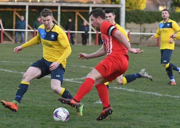 Ryhope CW skipper Kyle Davis (red) attacks the Whitley Bay defence last weekend. Picture by Kevin Brady