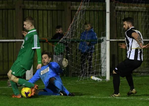 Tow Law defend against Easington Colliery (green) in last weekend's 3-0 away victory. Picture by Kevin Brady