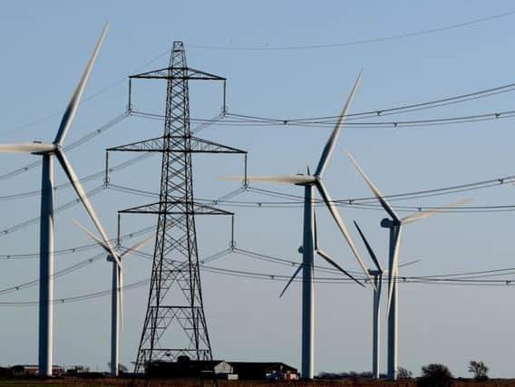 A view of the Little Cheyne Court Wind Farm amongst existing electricity pylons on the Romney Marsh in Kent as British wind farms generated more electricity than coal plants on more than 75% of days this year, figures show. Picture by Gareth Fuller/PA Wire
