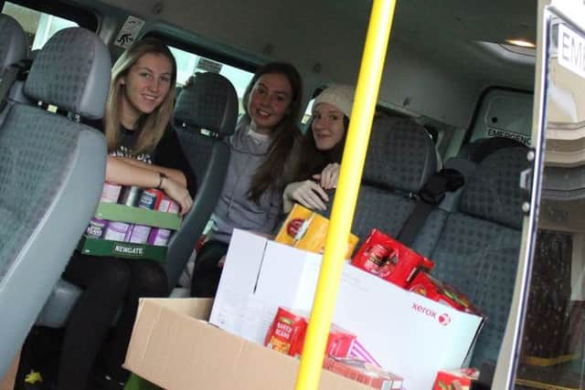 In transport, the students from Southmoor Academy taking the tinned food to be distributed.
