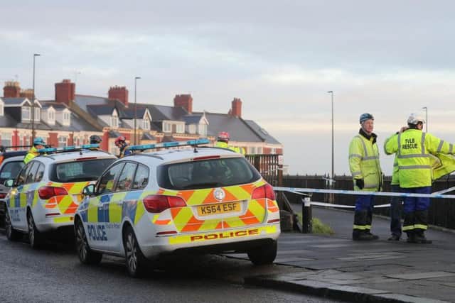 Members of the emergency services attend the scene at Browns Bay on the North East coast near Cullercoats after a body was found on the rocks by the sea. Photo by Press Association.