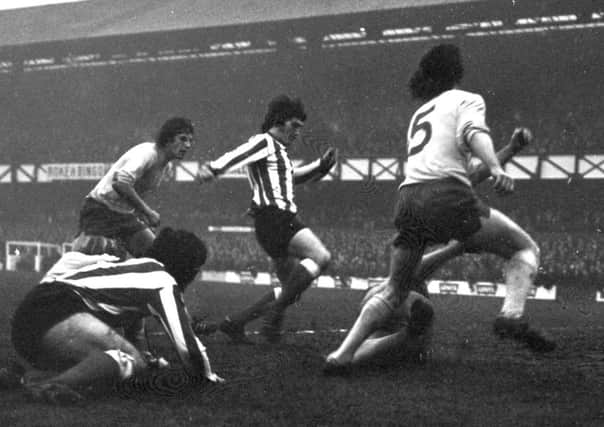 Sunderland forward John Lathan makes his presence felt against Brighton in 1973
