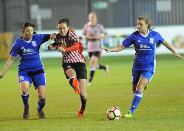 Sunderland captain Lucy Staniforth holds off Birmingham City's Rachel Williams.