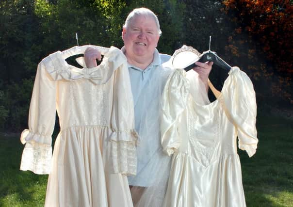 Dressmaker Kevin Thornhill with his copies of the wedding dresses worn by Lady Diana and Sarah Ferguson, right.