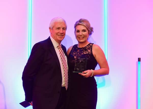Fundraiser of the Year winner Tara Middleton receives her trophy from SAFC legend Jimmy Montgomery.