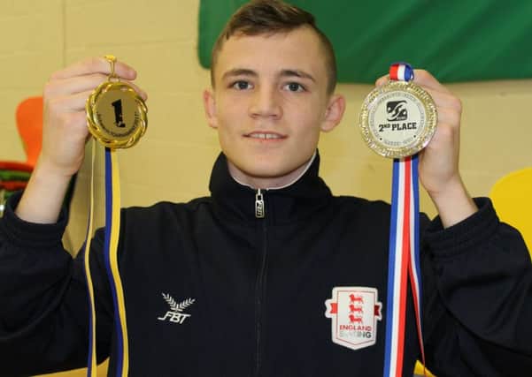 Boxer Rhys Deehan with his medals.