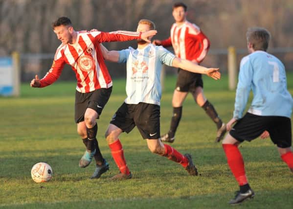 Sunderland West End (red/white) take on Silksworth CW in last week's Monkwearmouth Cup tie. Picture by Tim Richardson