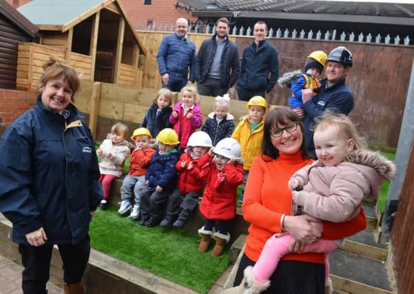 Pennywell Early Years Centre's new garden following an arson attack. Front headteacher Claire Nicholson with Bobbi Green, two, and  Heather Miller from Engie Regeneration.