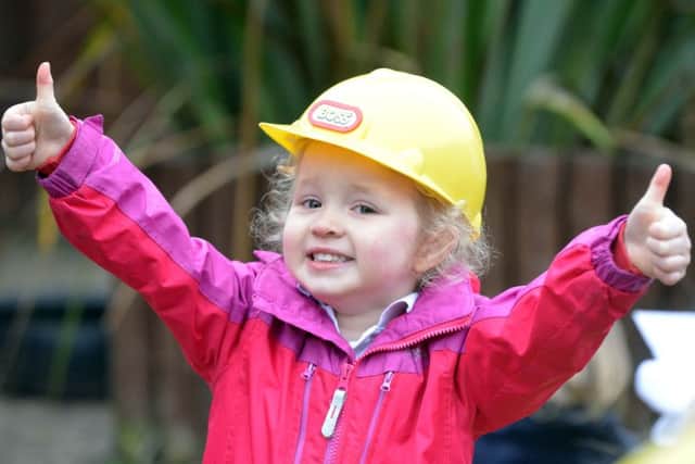 Pupil 
Hope Fleucher, two, gives thumbs-up to the new garden area.