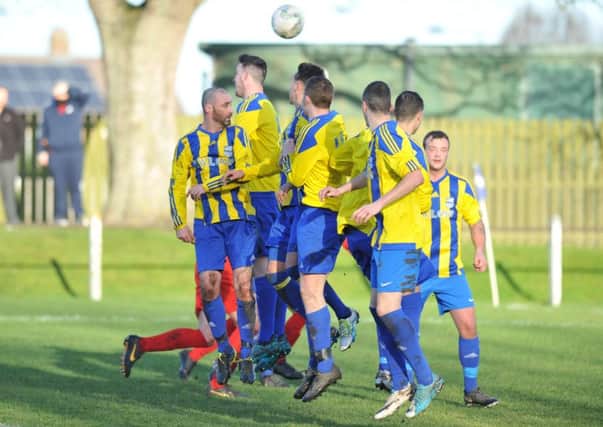 Hylton Castle TWR Group (stripes) defend a free-kick against Victoria Gardens in last weekend's Durham Sunday Cup tie. Picture by Tim Richardson