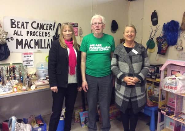 Karen Carr, of the Market Village at the Galleries in Washington, left, and Michelle Muir of Macmillan, right, with Roger Morrison at his fundraising stall.